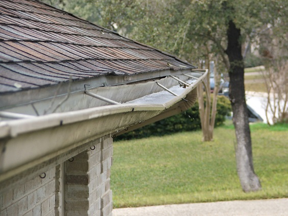 Residential gutter repair along a roof edge